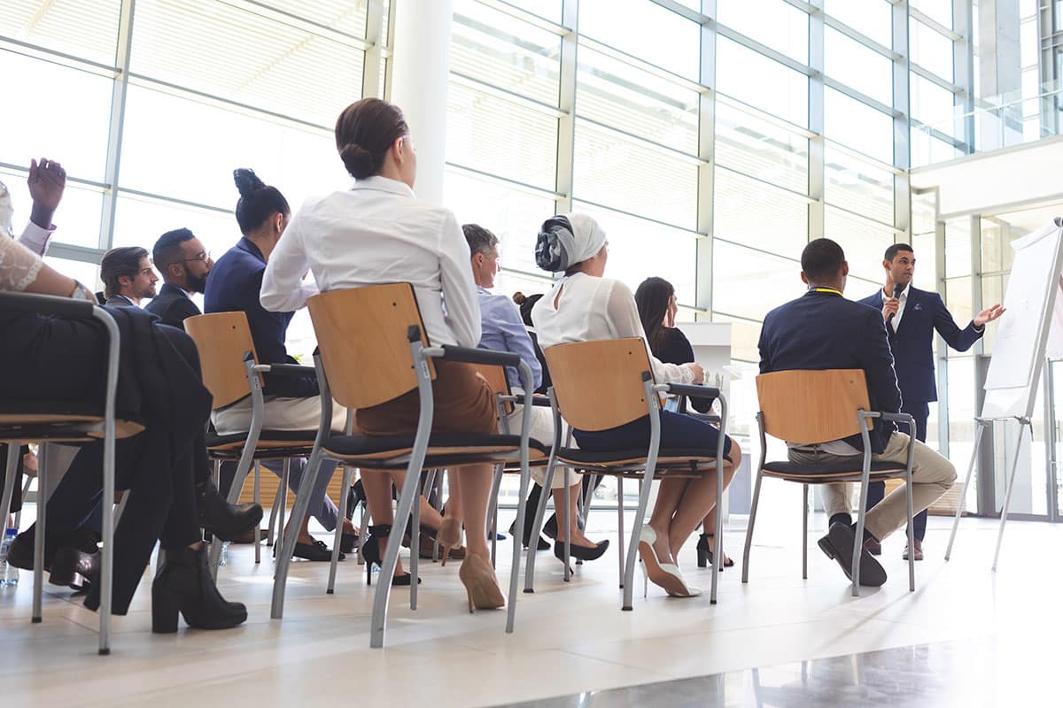 businessman showing information on flip chart to audience