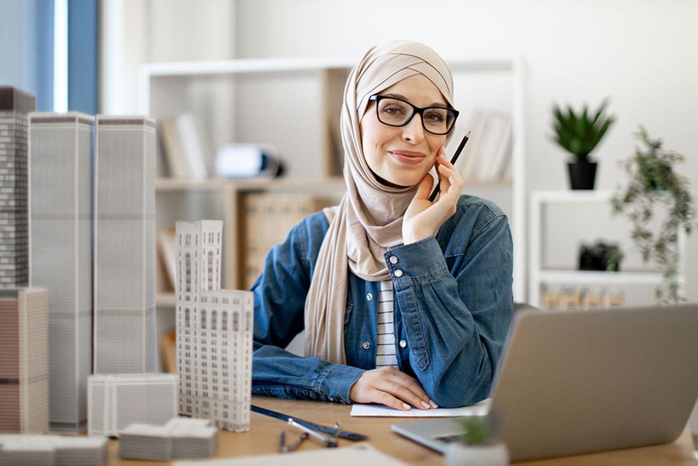 female working on laptop in real estate office