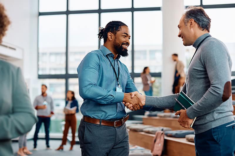 happy businessmen greeting while attending CE class