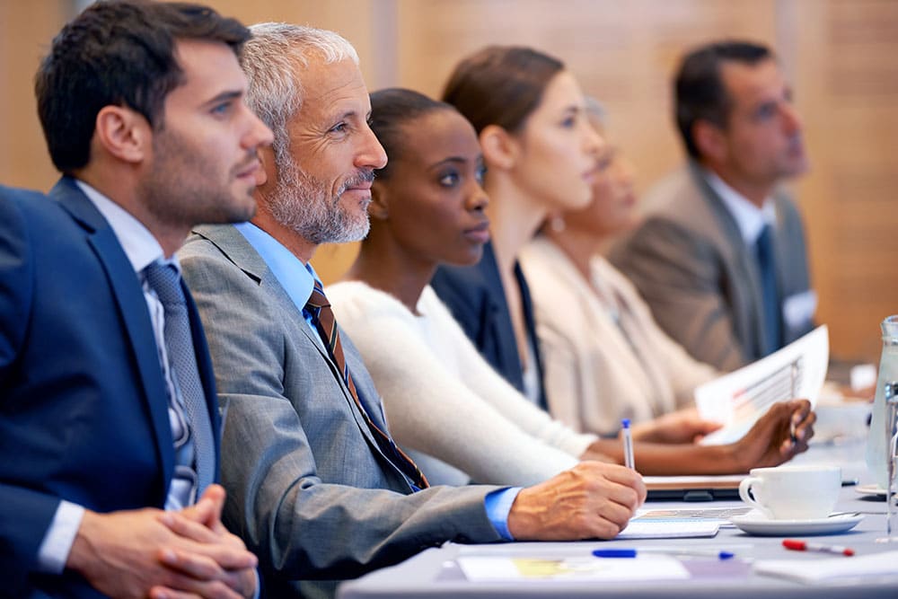 Group of people listening to CE class, taking notes